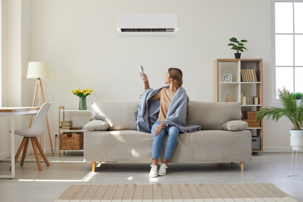 Woman controling heatpump heater with remote.